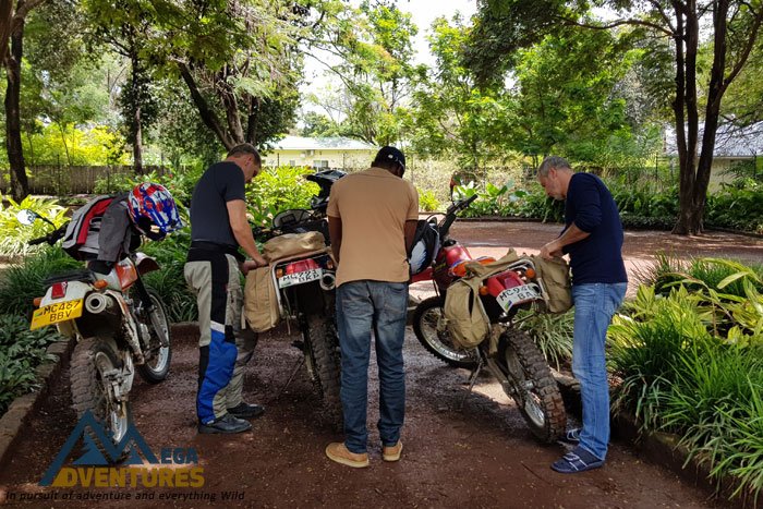 A 4x4 support vehicle and motorbikes on a dirt track in northern Tanzania