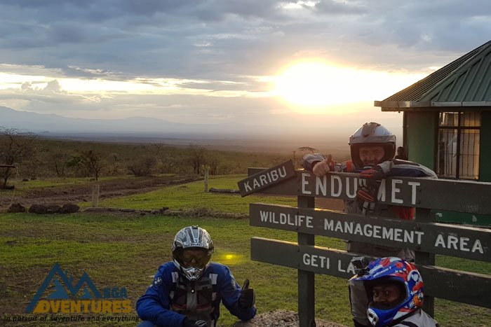 Riders on the dusty plains of West Kilimanjaro with the mountain behind
