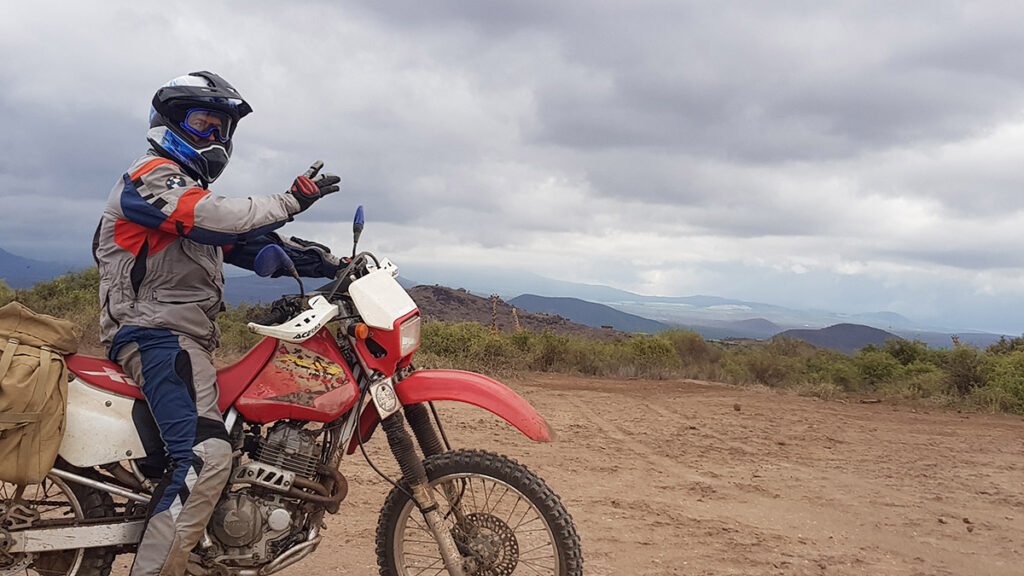 Rider on a dirt track below Kilimanjaro